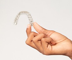 Closeup of holding clear aligner