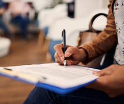 Patient filling out paperwork in lobby