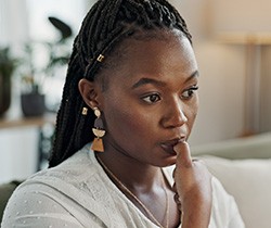 Closeup of woman biting her nails at home