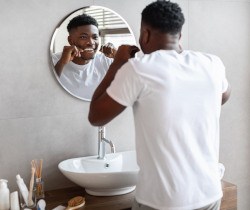 Man smiling while flossing