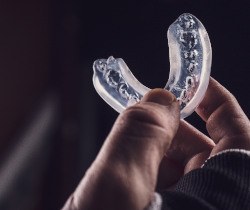 Closeup of holding clear mouthguard